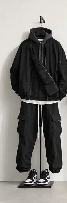 Black streetwear outfit on a hanger — one of three outfit photos to upload